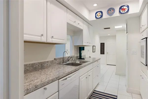 a kitchen with stainless steel appliances granite countertop a sink and cabinets
