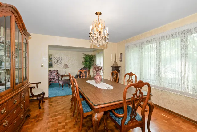 a view of a dining room with furniture and a chandelier