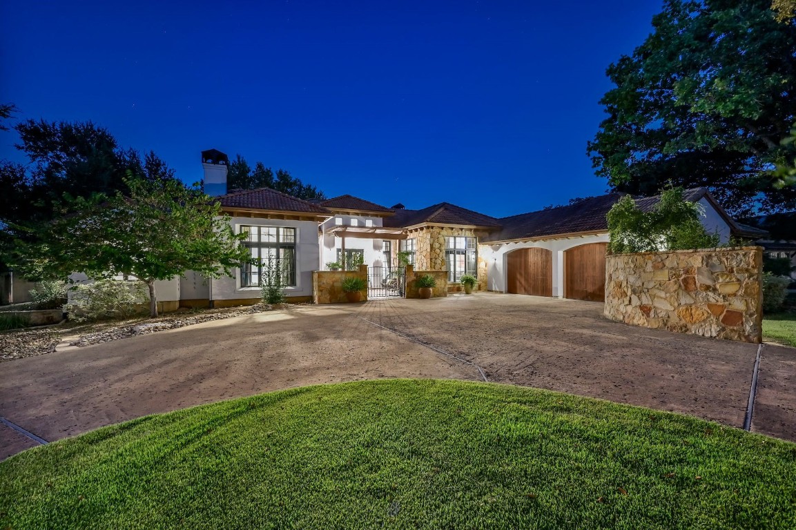 a view of a house with a yard and tree s
