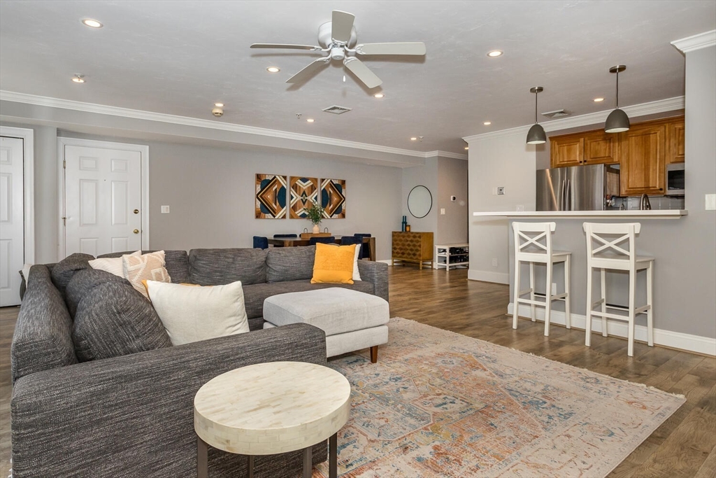 10 Forge Pond, Unit A Canton, MA 02021 - Photo 3 of 17 a living room with furniture and a wooden floor