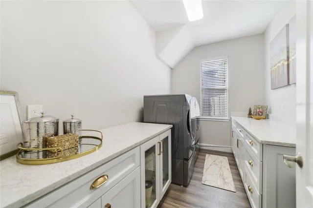 a kitchen with a sink appliances and cabinets