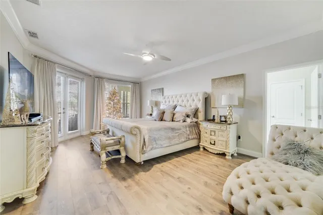 a bedroom with a bed and a large window