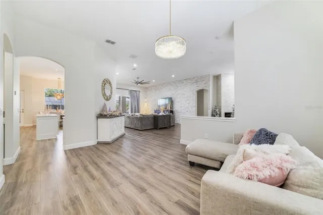 a living room with furniture and kitchen view