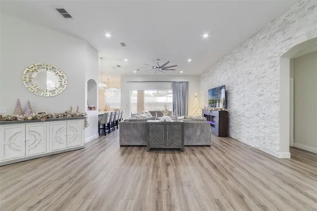 a large kitchen with a lot of counter space and wooden floor