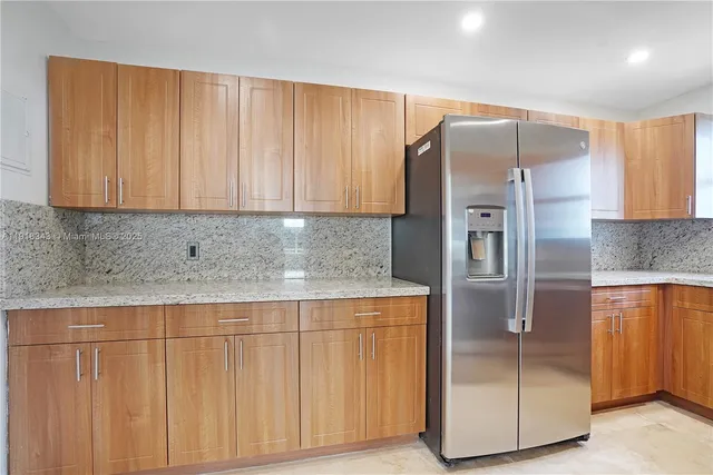 an empty room with an entryway and shower