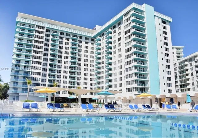 a view of swimming pool with a table and chairs
