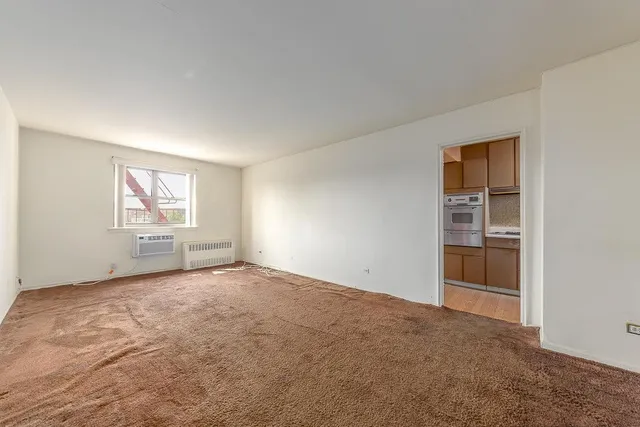 an empty room with windows and closet