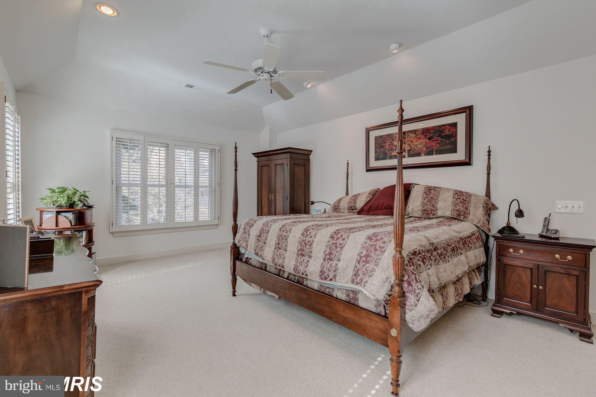 6900 Rannoch Road Bethesda, MD 20817 - Photo 13 of 22 a spacious bedroom with a bed a dresser and potted plant