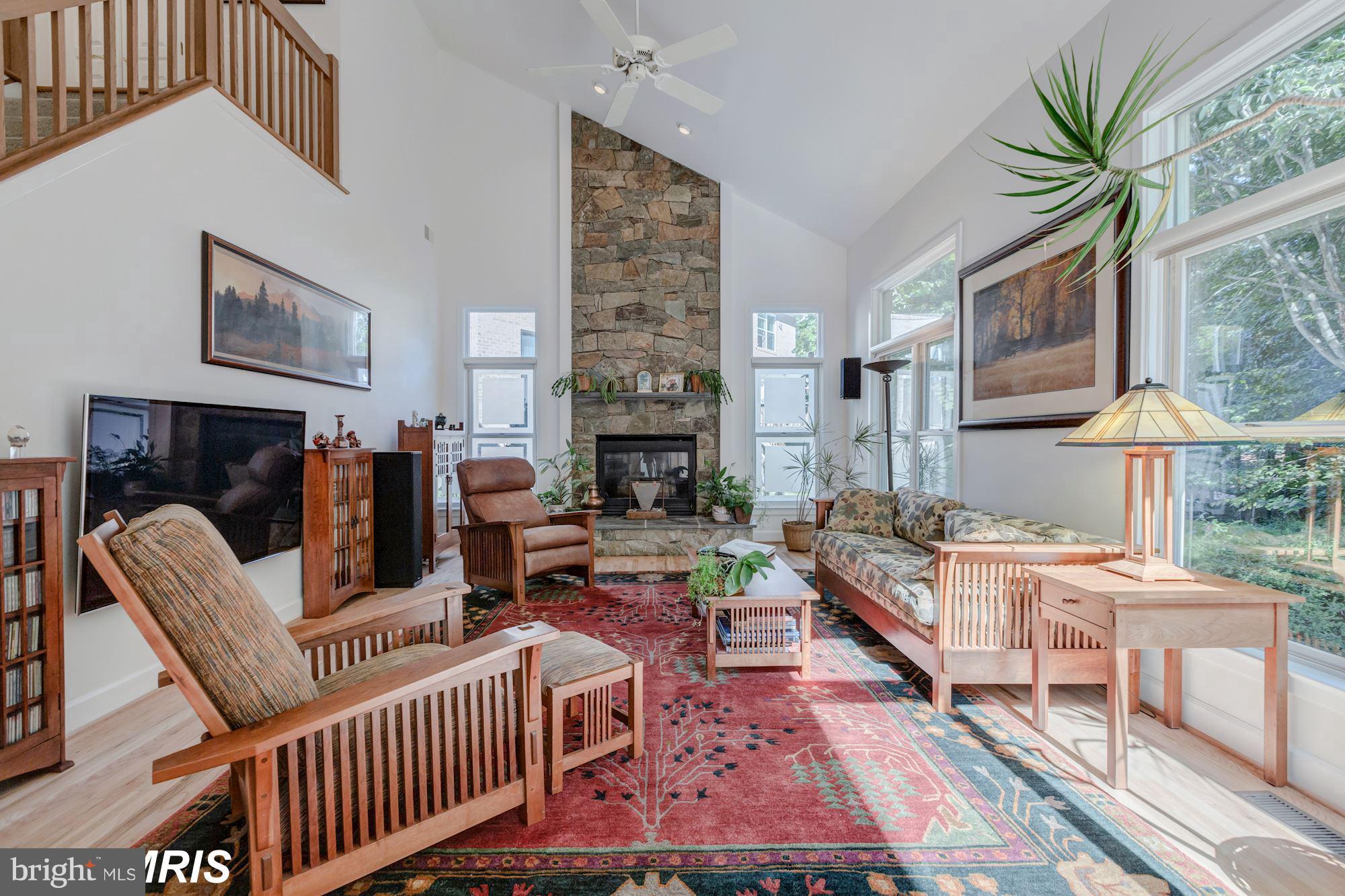 6900 Rannoch Road Bethesda, MD 20817 - Photo 7 of 22 a living room with furniture a chandelier and a fireplace