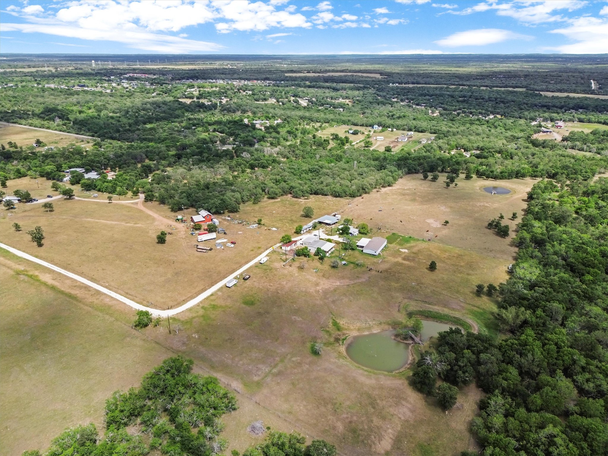 480 Grandpa Road Lockhart, TX 78644 - Photo 34 of 35 The property itself is a private
haven with a fishing pond, mature trees, cross-fencing for livestock, a corral, and wide-open skies that deliver
unforgettable sunsets.