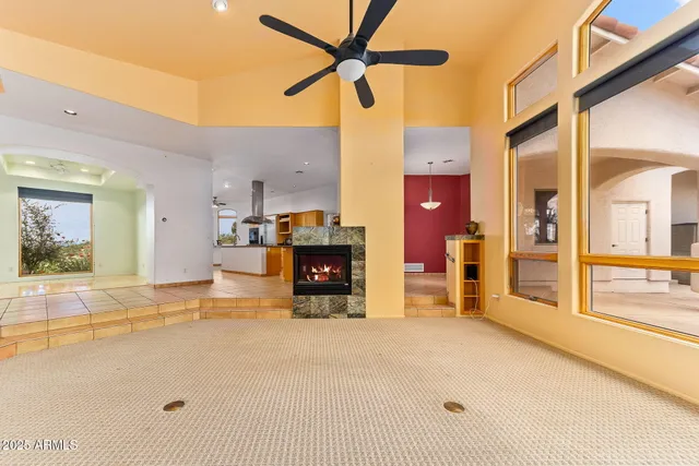 a large kitchen with granite countertop a large counter top space and stainless steel appliances