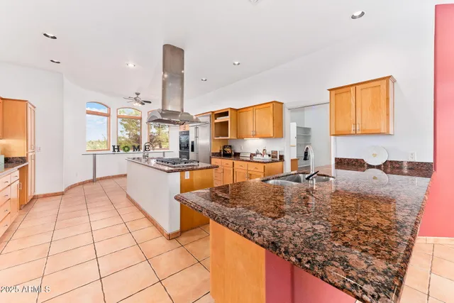 a kitchen with granite countertop a stove and a sink