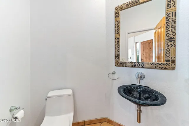 a spacious bathroom with a granite countertop sink and a mirror
