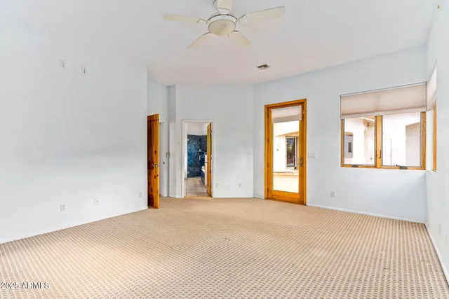 a view of an empty room with glass door