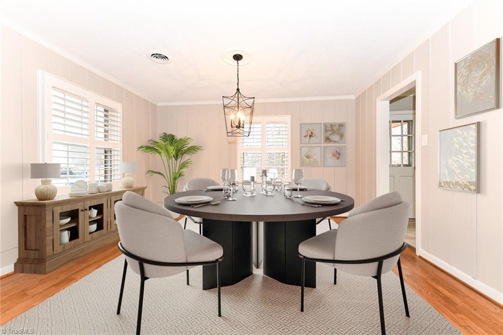 2010 Trosper Road Greensboro, NC 27455 - Photo 6 of 25 Formal dining room with refinished hardwood floors, plantation shutters and new light fixtures, opens to the living room