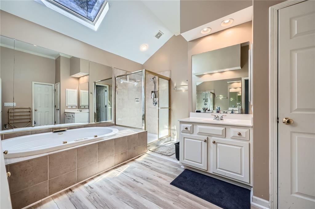 5106 Vining Estates Way Mableton, GA 30126 - Photo 13 of 28 a spacious bathroom with a tub sink shower and mirror