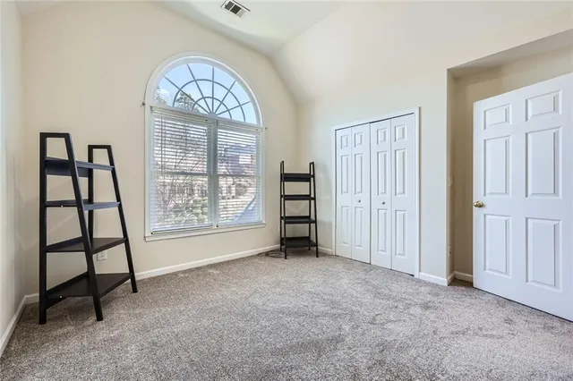 an empty room with windows closet and mountain view