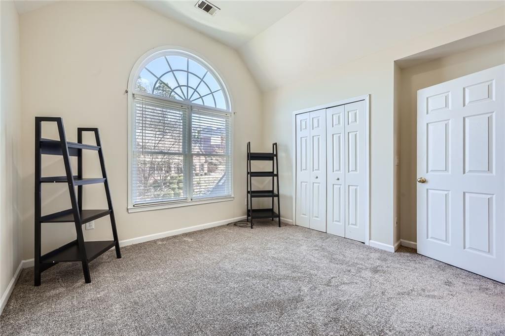 5106 Vining Estates Way Mableton, GA 30126 - Photo 17 of 28 an empty room with windows closet and mountain view