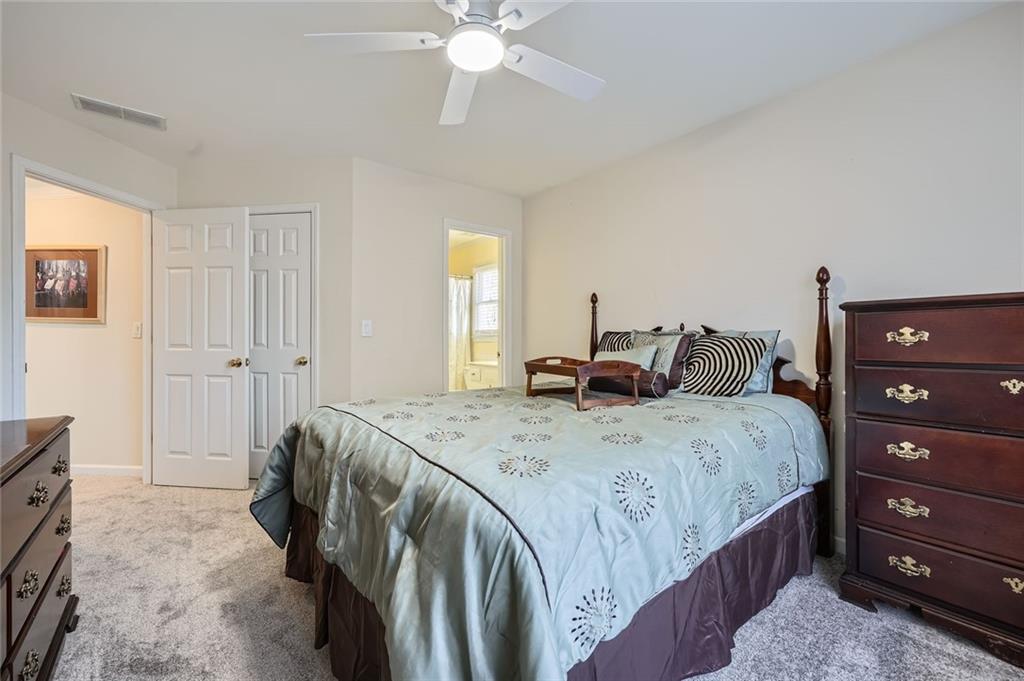 5106 Vining Estates Way Mableton, GA 30126 - Photo 18 of 28 a bedroom with a bed and a dresser