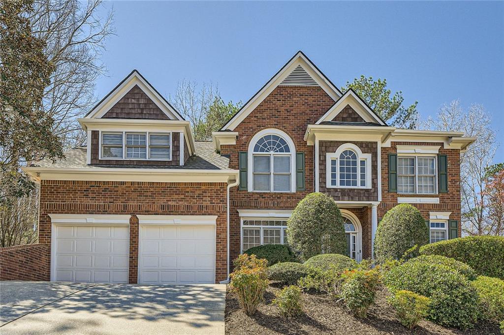 5106 Vining Estates Way Mableton, GA 30126 - Photo 2 of 28 a front view of a house with a yard and garage