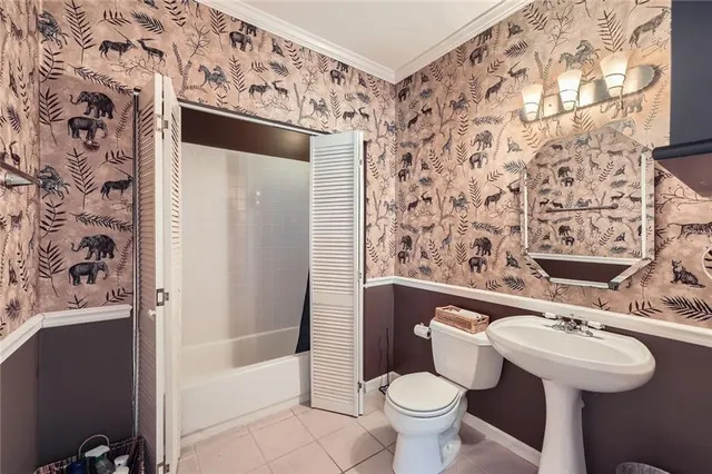a bathroom with a sink and mirror with toilet