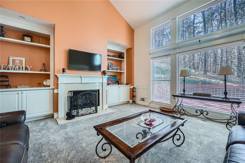 5106 Vining Estates Way Mableton, GA 30126 - Photo 4 of 28 a living room with furniture a flat screen tv and a fireplace