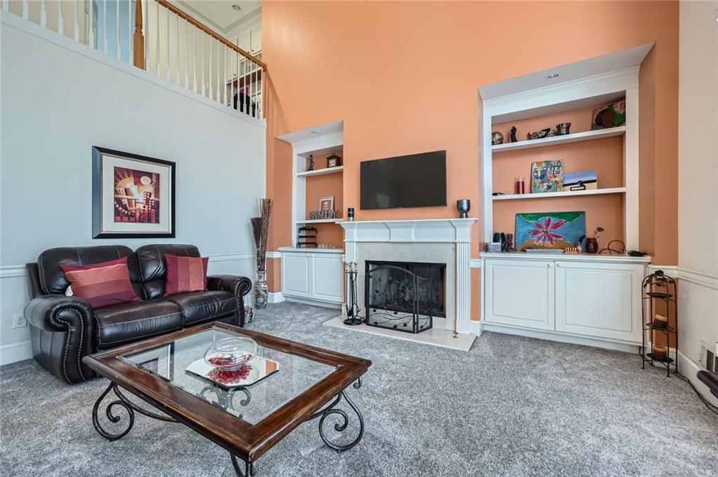 5106 Vining Estates Way Mableton, GA 30126 - Photo 5 of 28 a living room with furniture a rug and a fireplace
