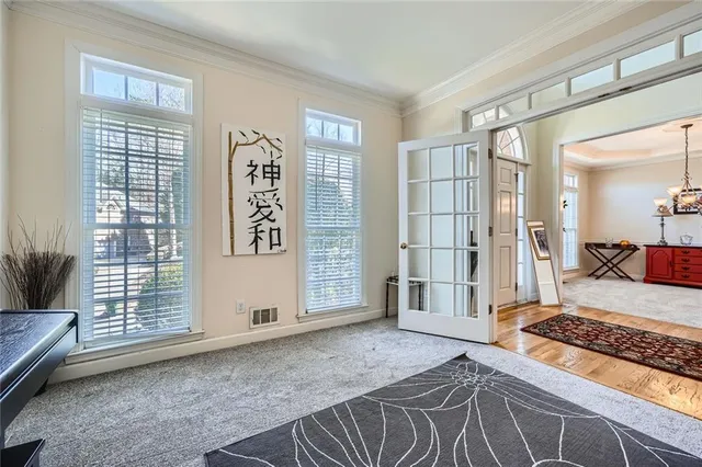 a spacious bedroom with a bed and glass door