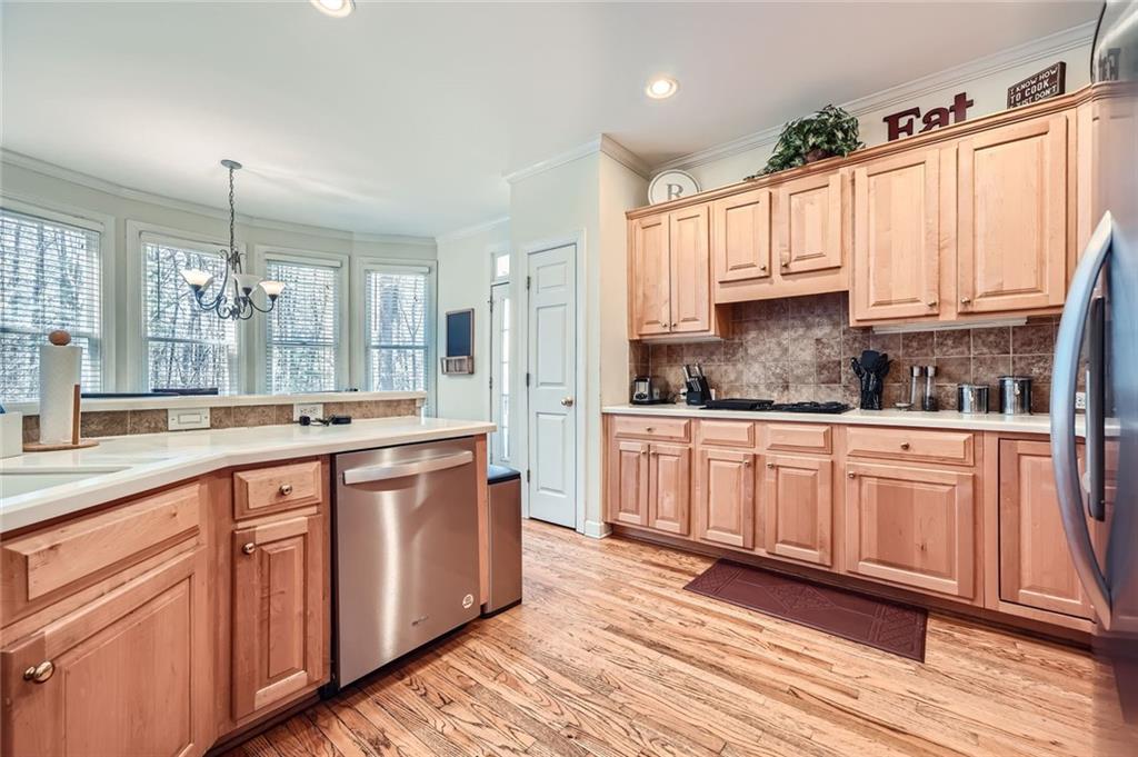 5106 Vining Estates Way Mableton, GA 30126 - Photo 9 of 28 a large kitchen with stainless steel appliances granite countertop a lot of counter space and wooden floors