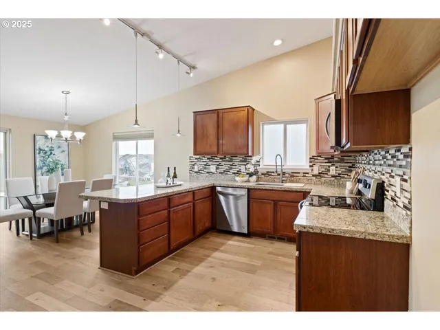 a kitchen with sink a stove and cabinets