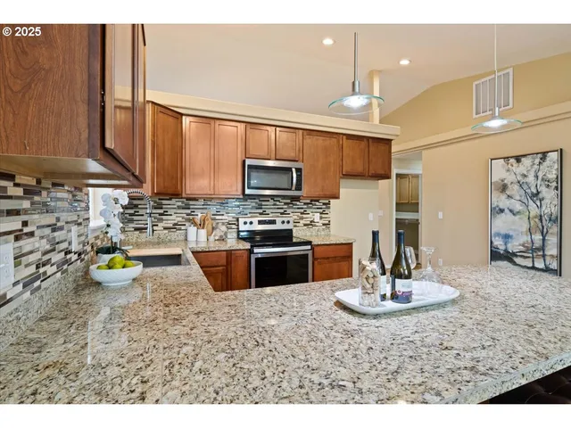 a kitchen with a sink a stove and cabinets