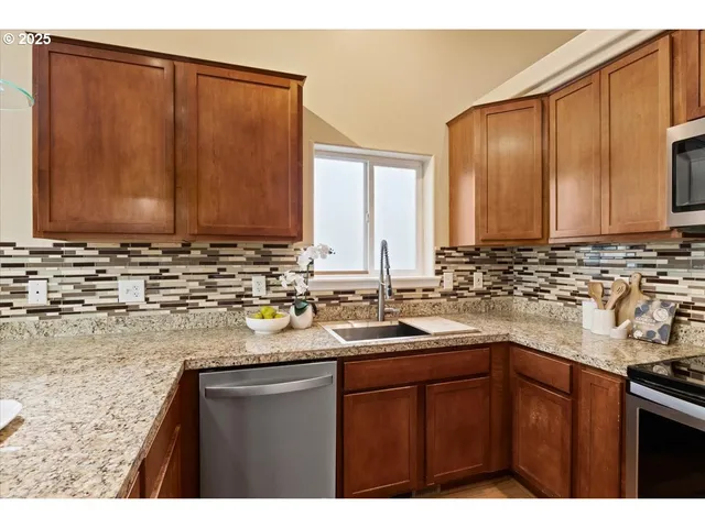 a kitchen with sink and cabinets