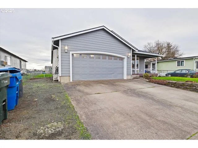 a view of a house with a backyard and road