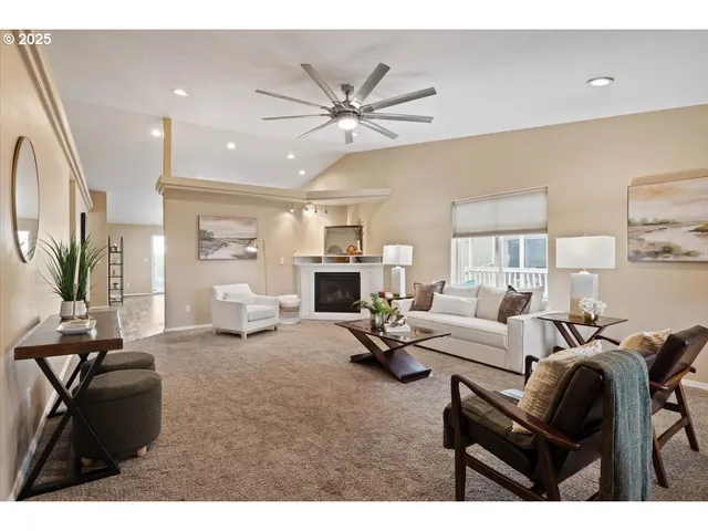a living room with furniture a fireplace and a flat screen tv