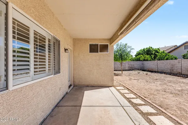 a view of house with backyard and sitting space