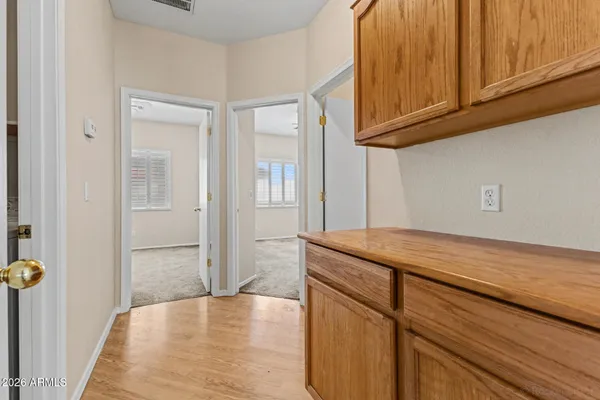 a kitchen with stainless steel appliances granite countertop a sink and cabinets with wooden floor