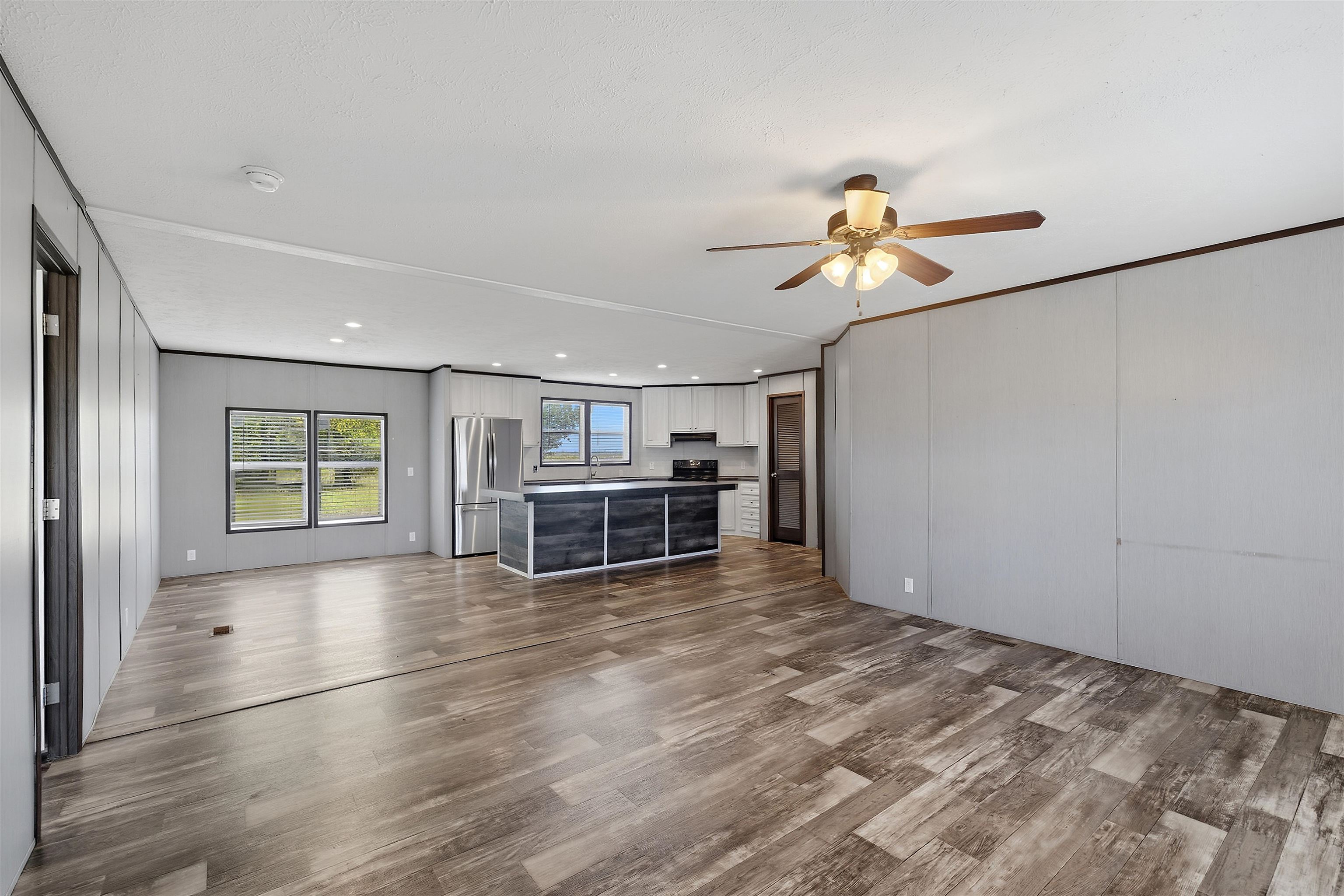 Open-concept living space with wood-finish flooring