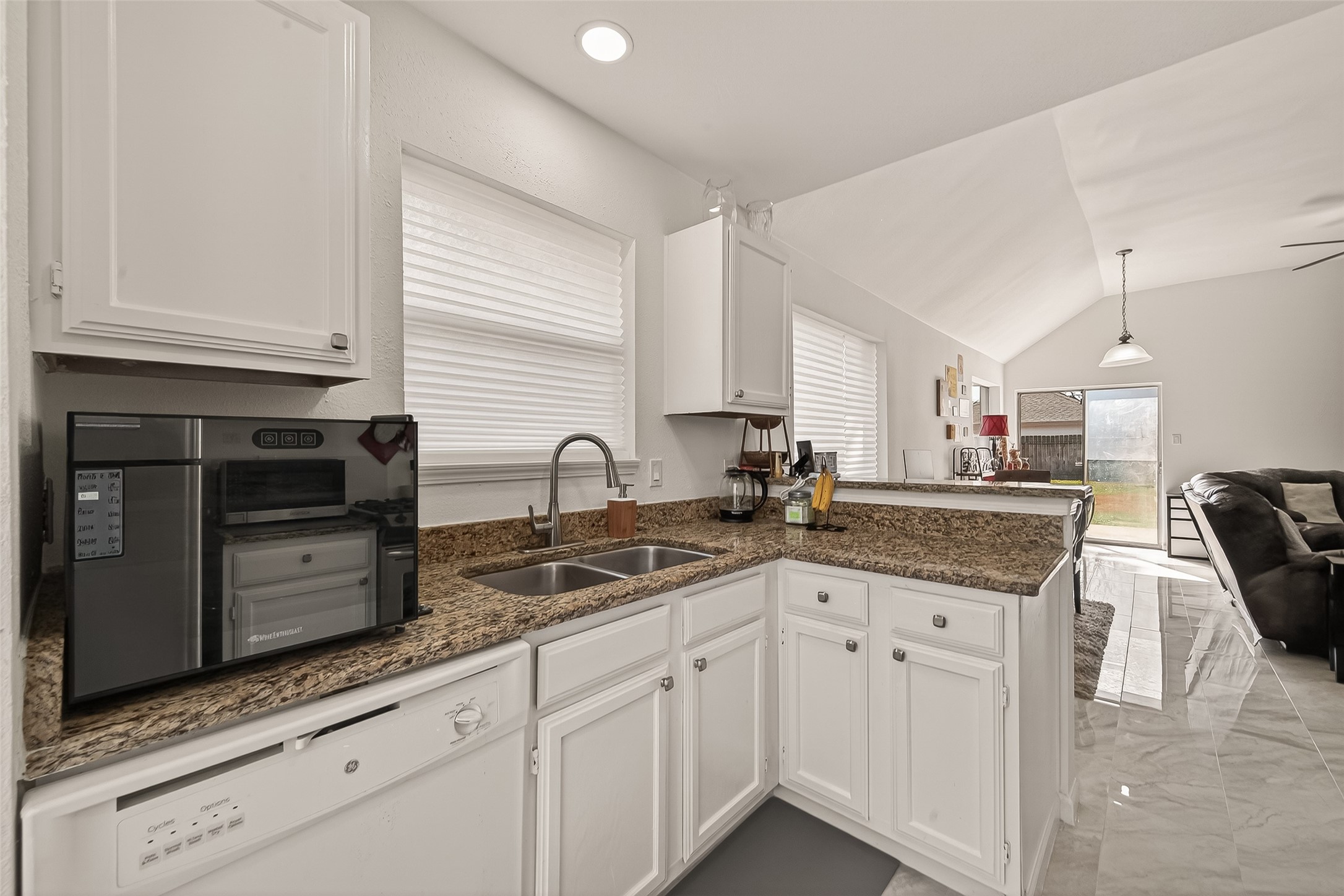 21067 Southern Colony Court Katy, TX 77449 - Photo 5 of 19 a kitchen with granite countertop a sink a stove and cabinets