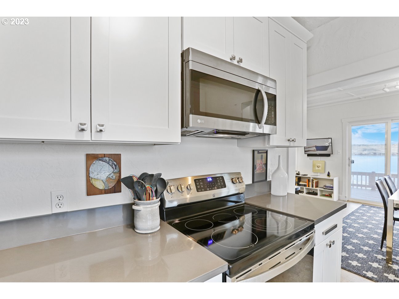 23586 Northwest St Helens Road, Unit U62 Portland, OR 97231 - Photo 8 of 25 a kitchen with stainless steel appliances granite countertop a sink and a microwave