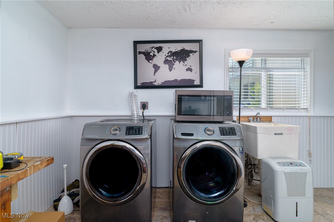 5497 Lear Nagle Road North Ridgeville, OH 44039 - Photo 27 of 33 washer and dryer stay with home in this nice laundry room. Wainscot walls and stationary tub