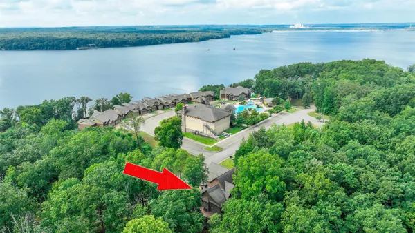 an aerial view of residential house with outdoor space and lake view