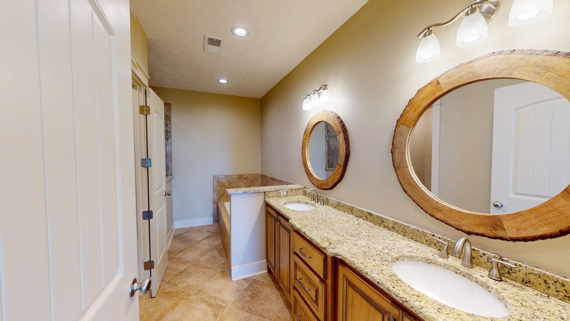 540 Breathtaking Loop Savannah, TN 38372 - Photo 23 of 40 a bathroom with a granite countertop double vanity sink and a mirror