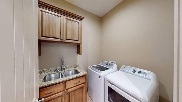 an empty room with wooden floor and ceiling fan