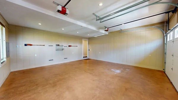 a view of a room with wooden floor a ceiling fan and a fireplace