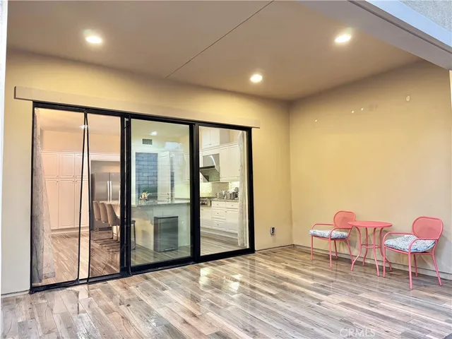 a view of a room with wooden floor and furniture