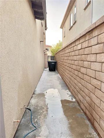 a view of a hallway with wooden floor and bathroom view