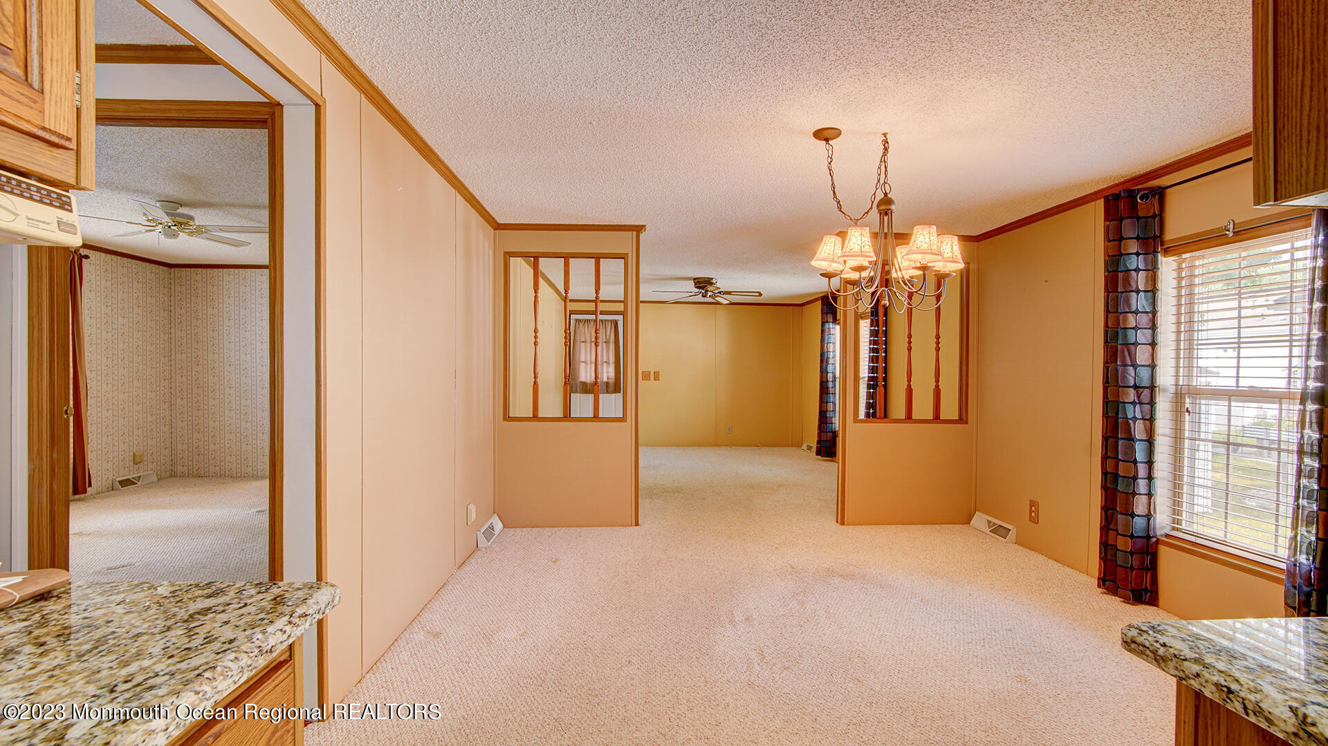 76 Village Road Morganville, NJ 07751 - Photo 1 of 27 a view of a hallway with a chandelier