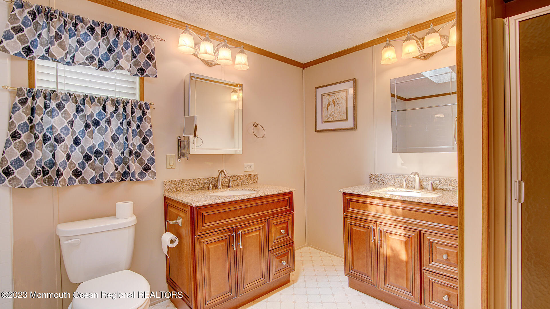 76 Village Road Morganville, NJ 07751 - Photo 13 of 27 a bathroom with a granite countertop sink mirror vanity and toilet