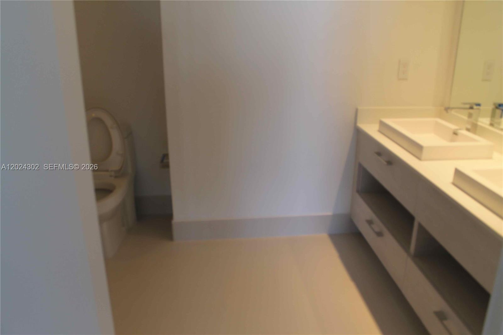 45 Southwest 9th Street, Unit 2109 Miami, FL 33130 - Photo 12 of 40 a bathroom with a sink and a mirror