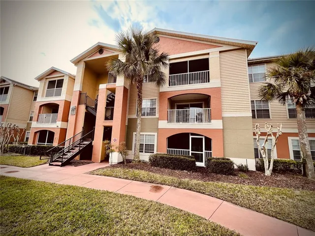 a front view of multiple houses with yard